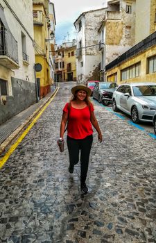 Woman with a hat walking through the streets of Segorbe