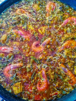 Typical Spanish food of rice, meat and vegetables in special flat casserole for this meal