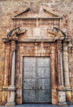 Old metal door with stone ornament in a church
