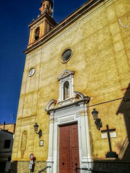 View of brown stone church and white door of Navajas