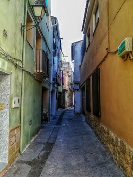 Beautiful little street with houses painted in different colors in the town of Navajas