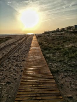 Wooden walkway to access the beach with the Mediterranean Sea in the background