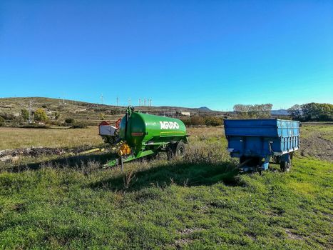 El Toro, Spain 10/24/2018: Tractor trailers in the field with mountains in the background