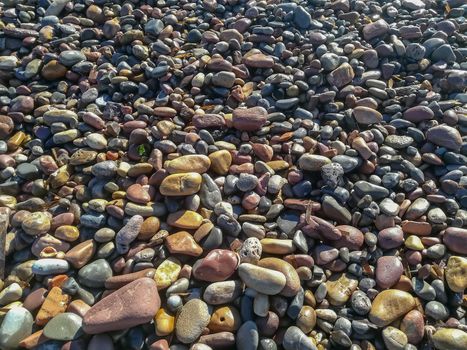 Rounded stones on the beach of different colors