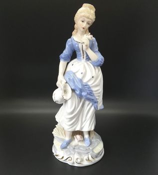 Ceramic figures of people on black background