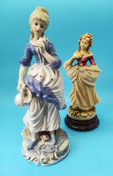 Ceramic figures of people on blue background