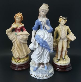 Ceramic figures of people on black background