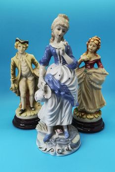 Ceramic figures of people on blue background