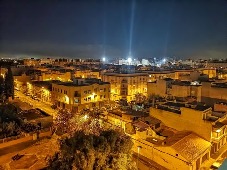 Night view of the town of Burriana with the lights of the San Fernando Stadium in the background