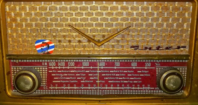 View of old golden radio with red control panel
