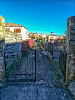 Old metal access door to an unpaved street