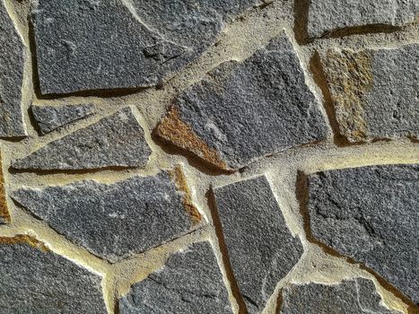 Facade of natural stone and gray cement