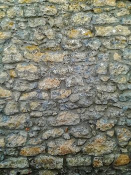 Facade of natural stone and gray cement