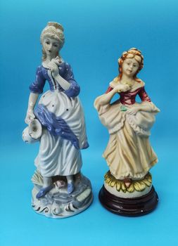 Ceramic figures of people on blue background