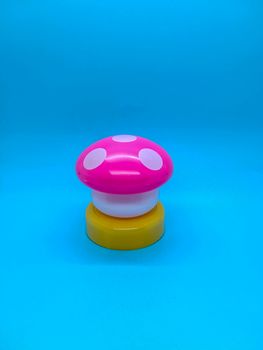 Toy mushroom shaped lamp on a blue background