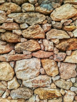 Brown stone wall built manually without the help of cement