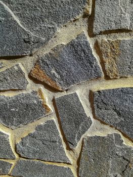 Facade of natural stone and gray cement