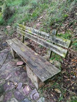 Old stone and wood bench in the mountain