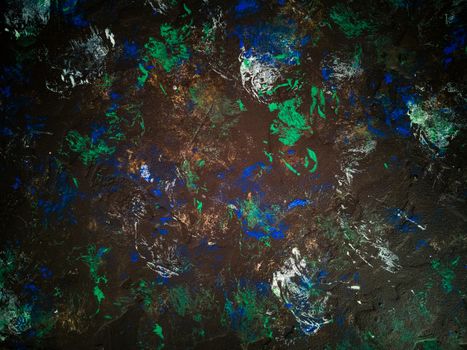 Rugged black background with green and blue blots