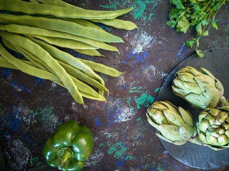 Orchard vegetables in composition on dark and rough background