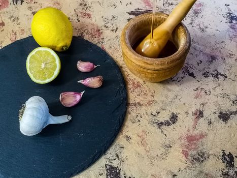 Ingredients and utensils to make mayonnaise with garlic in composition on light background