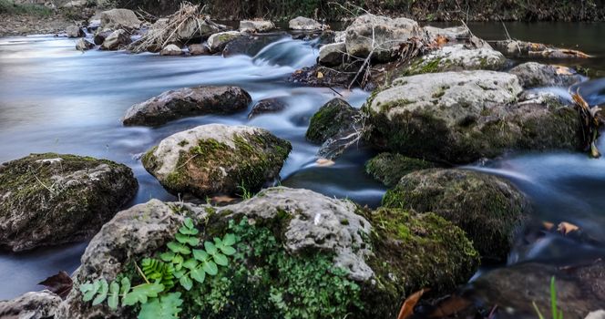 Palancia river water flowing through rocks in long exposure