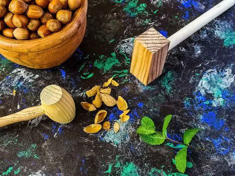 Walnuts and hazelnuts in composition on dark and rough background