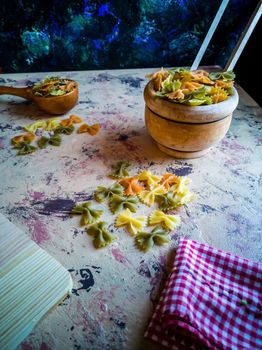 Colorful pasta ties in composition on light and rough background