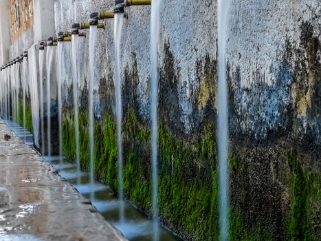 Source of 50 pipes with faucets aged and aligned
