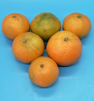 Small orange in composition on blue background