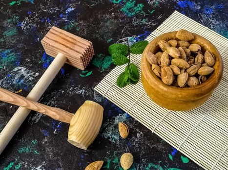 Walnuts and hazelnuts in composition on dark and rough background