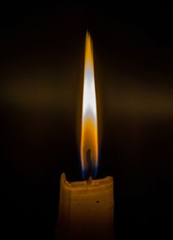Matches burning to light a candle on black background
