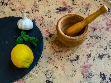 Ingredients and utensils to make mayonnaise with garlic in composition on light background