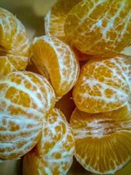 View of peeled small oranges piled up