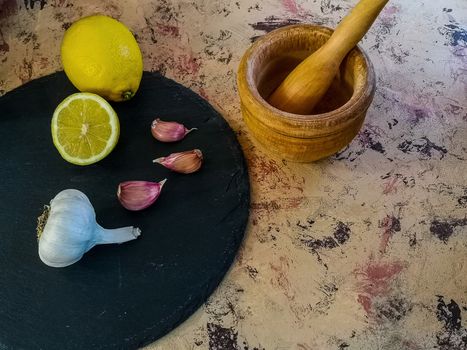 Ingredients and utensils to make mayonnaise with garlic in composition on light background