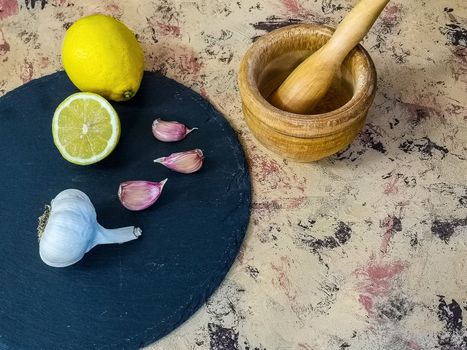 Ingredients and utensils to make mayonnaise with garlic in composition on light background