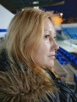 Pretty woman with lost eyes on a soccer field