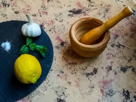 Ingredients and utensils to make mayonnaise with garlic in composition on light background