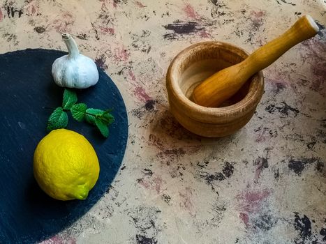 Ingredients and utensils to make mayonnaise with garlic in composition on light background