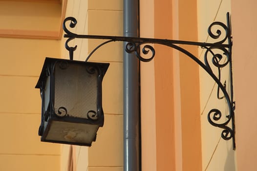 Vintage retro old style lantern on a orange wall