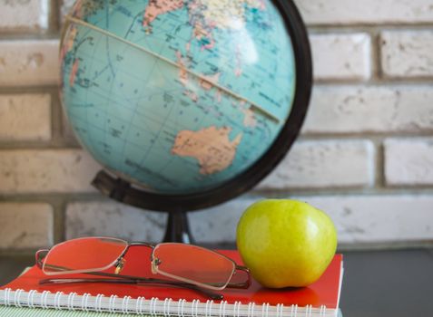 World teachers ' Day in school. Still life with books, globe, Apple glasses