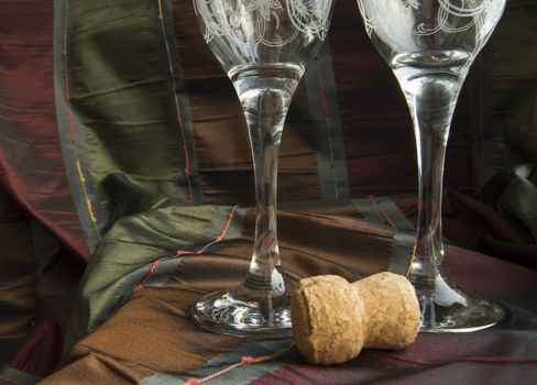 Two empty glasses of champagne and the cork close-up.