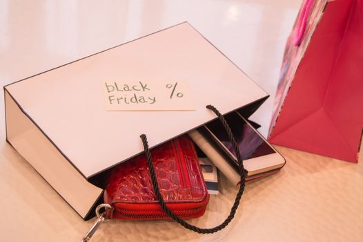 Closeup of bag with a purchase card, wallet, phone. Concept sales, black Friday.