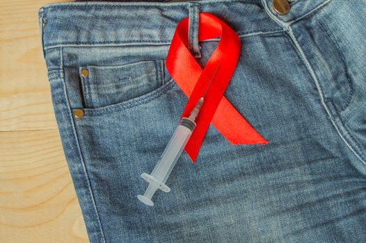 awareness AIDS red ribbon on jeans, a symbol of opposition