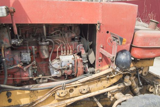 Close-up of old dirty tractor diesel engine parts.