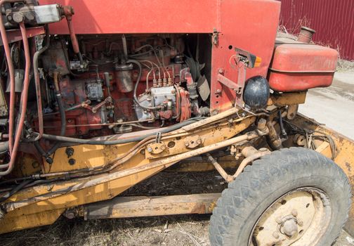 Close-up of old dirty tractor diesel engine parts.