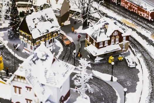 miniature city in winter - with houses, roads, cars, railway