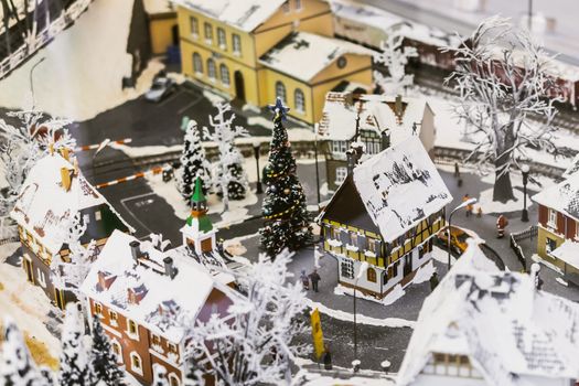 miniature city in winter - with houses, roads, cars, railway