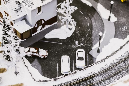 miniature city in winter - with houses, roads, cars, railway