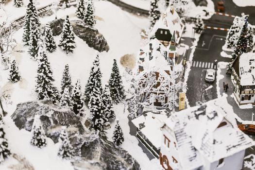 miniature city in winter - with houses, roads, cars, railway